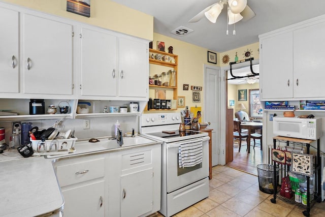 kitchen featuring white appliances, visible vents, a ceiling fan, light countertops, and open shelves