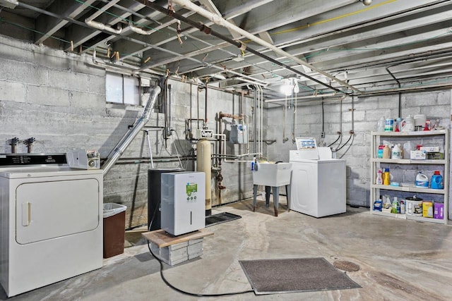 unfinished basement with a sink and washing machine and clothes dryer