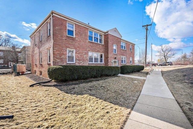 view of side of property featuring brick siding