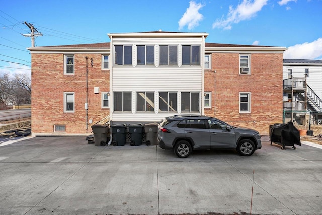 rear view of property with brick siding