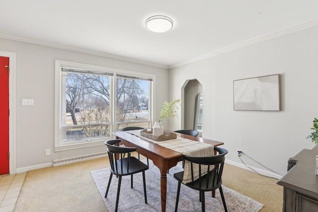 dining room featuring baseboards, arched walkways, ornamental molding, light colored carpet, and baseboard heating