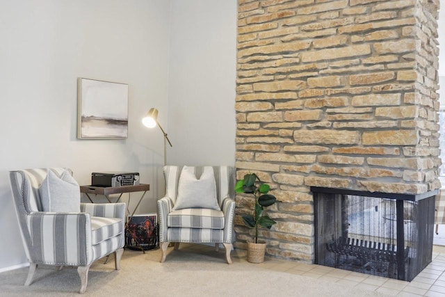 living area featuring carpet flooring and a fireplace