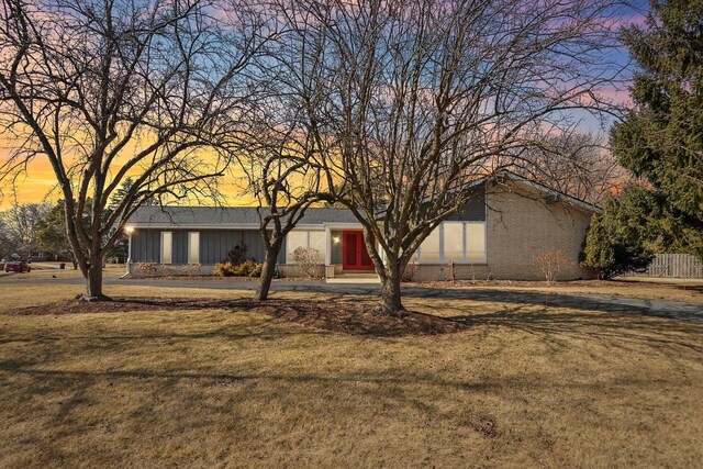 mid-century home with a front lawn