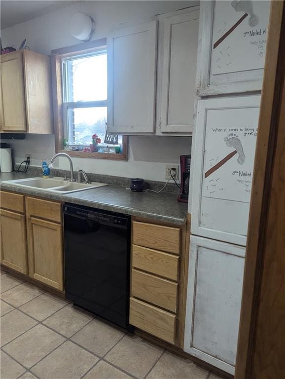 kitchen with dark countertops, black dishwasher, a sink, and light tile patterned floors