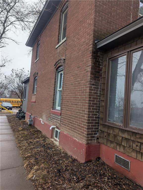 view of side of home with brick siding