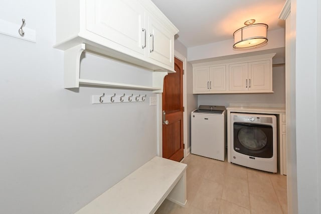 washroom featuring cabinet space and washer and dryer