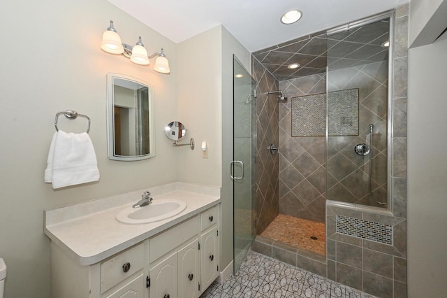 full bath featuring toilet, recessed lighting, vanity, tile patterned floors, and a stall shower