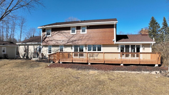 rear view of property featuring a deck and a chimney