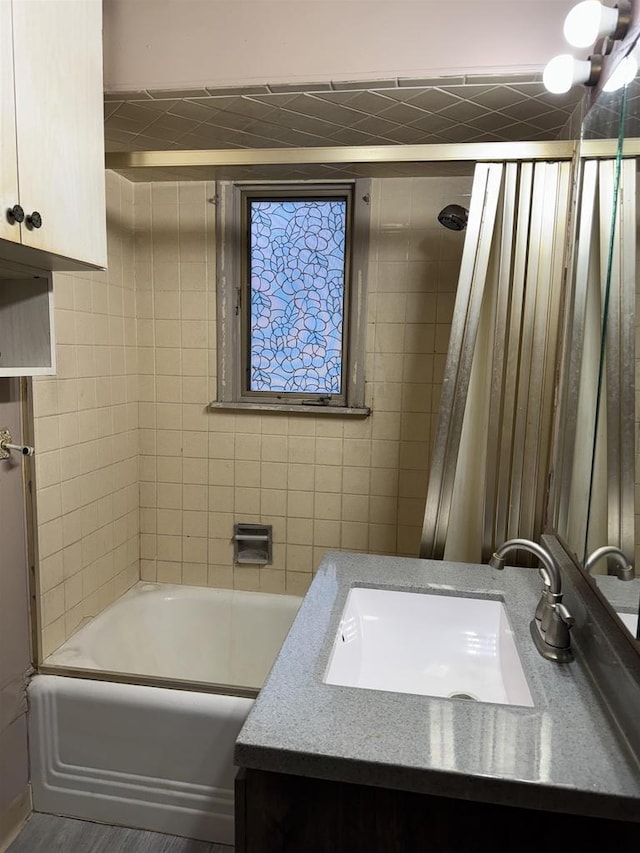 bathroom featuring washtub / shower combination and vanity