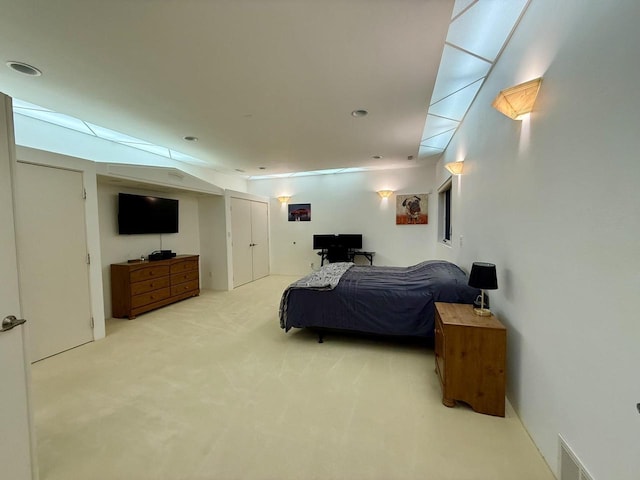 bedroom featuring light carpet, visible vents, and recessed lighting