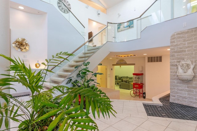 building lobby featuring stairway and visible vents