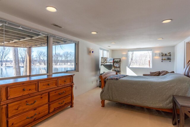 bedroom featuring recessed lighting, visible vents, and light carpet