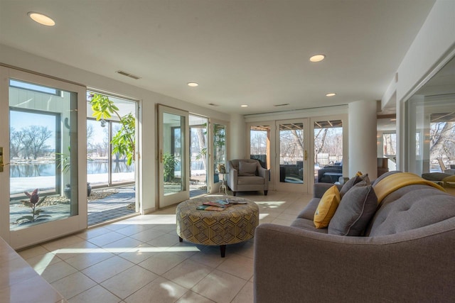 living room with light tile patterned floors, recessed lighting, visible vents, and a healthy amount of sunlight