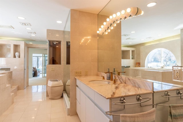 bathroom featuring tile patterned flooring, visible vents, tile walls, and recessed lighting