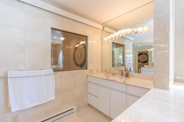 bathroom featuring a baseboard radiator, tile patterned flooring, tile walls, and vanity