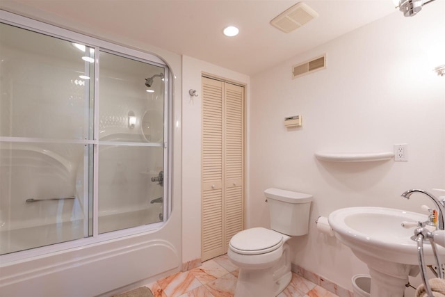 bathroom with toilet, shower / bath combination with glass door, visible vents, and a closet