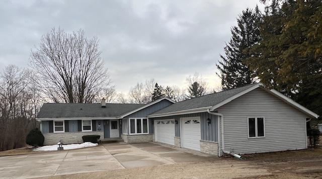 single story home with a garage and driveway