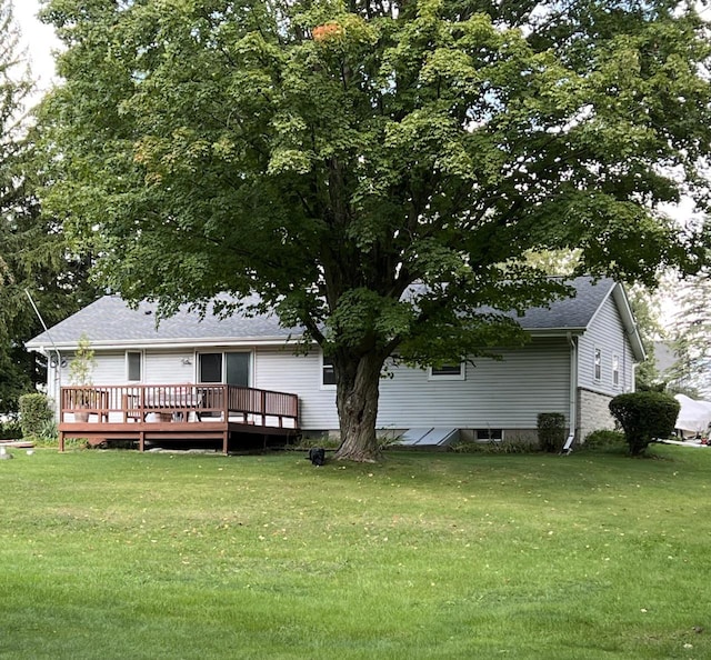 back of house with a lawn and a wooden deck