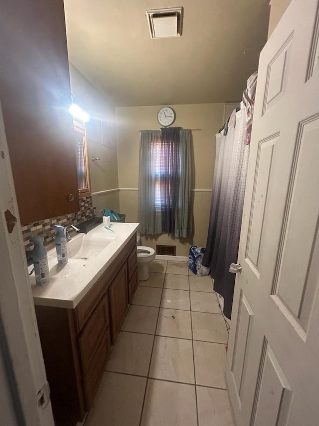 full bathroom with visible vents, vanity, toilet, and tile patterned floors