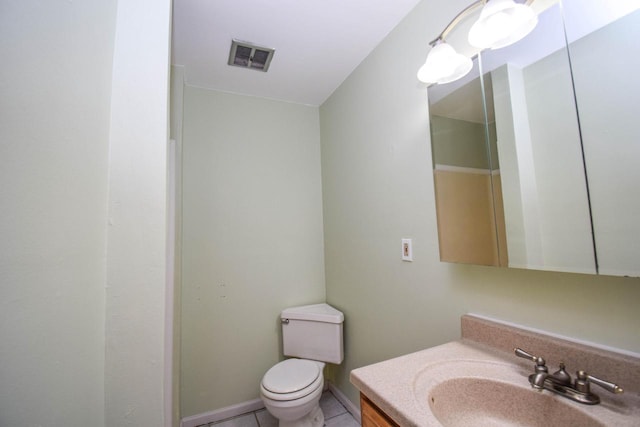 bathroom featuring visible vents, toilet, vanity, tile patterned flooring, and baseboards