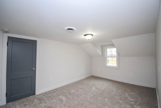 bonus room with lofted ceiling, baseboards, visible vents, and carpet flooring