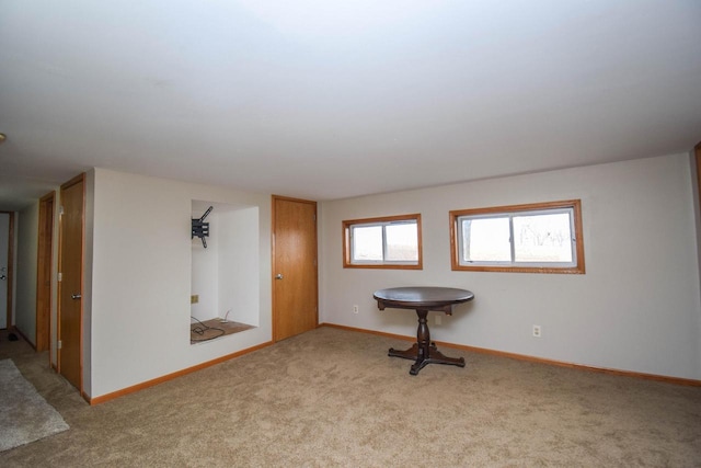 carpeted empty room featuring baseboards