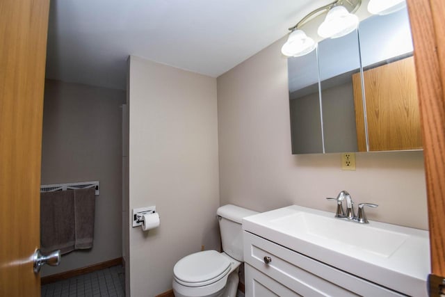 bathroom with vanity, toilet, and baseboards