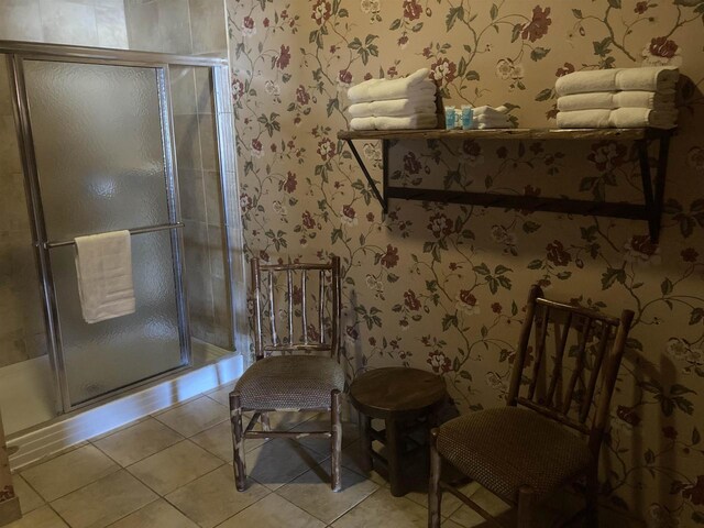 sitting room featuring wallpapered walls and light tile patterned floors