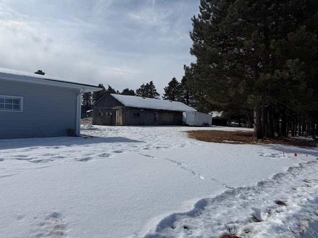 yard covered in snow with a garage