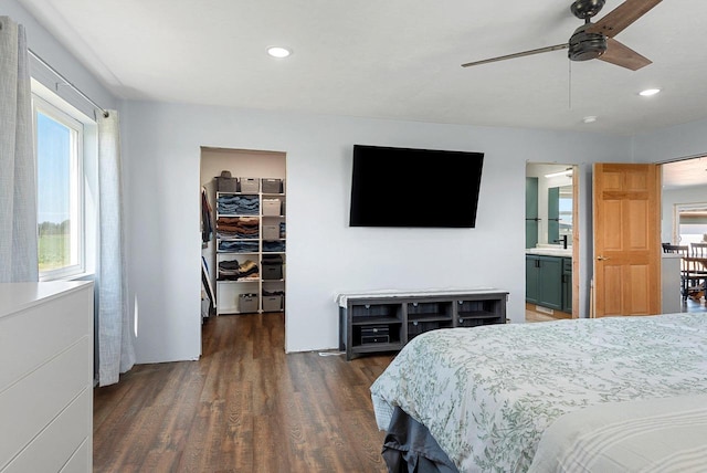 bedroom with a walk in closet, recessed lighting, a closet, connected bathroom, and wood finished floors