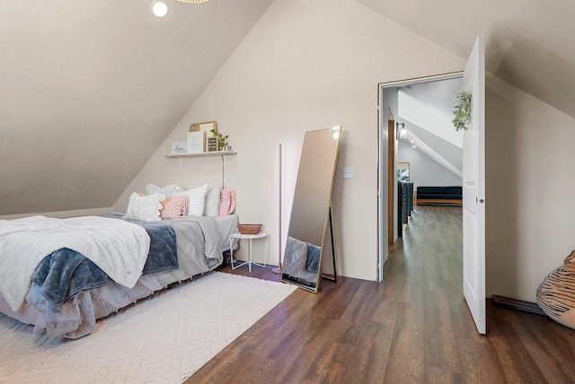 bedroom with lofted ceiling and wood finished floors