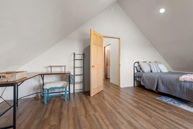 bedroom with lofted ceiling and wood finished floors