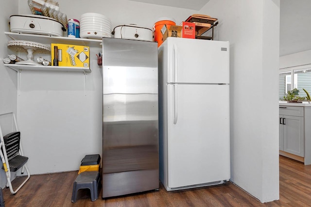 kitchen featuring dark wood-style floors and freestanding refrigerator