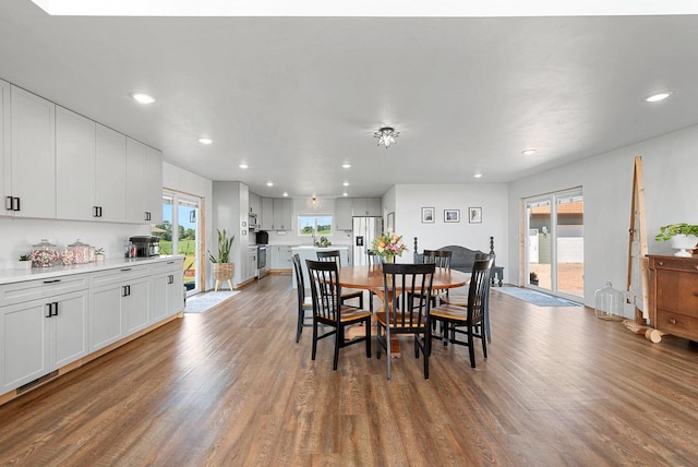 dining room with wood finished floors and recessed lighting