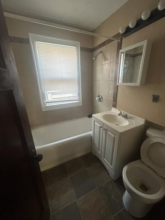 full bath with toilet,  shower combination, and vanity