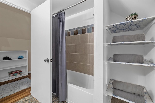 bathroom with shower / bath combo and wood finished floors