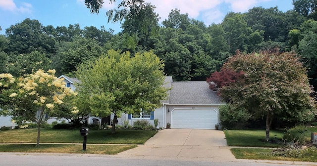 obstructed view of property featuring driveway, a shingled roof, a garage, and a front lawn