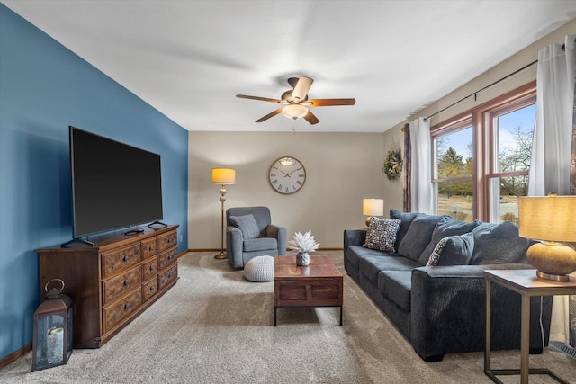 living room with carpet, a ceiling fan, and baseboards