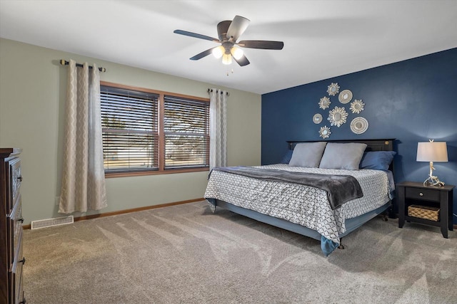 bedroom with carpet floors, visible vents, baseboards, and a ceiling fan