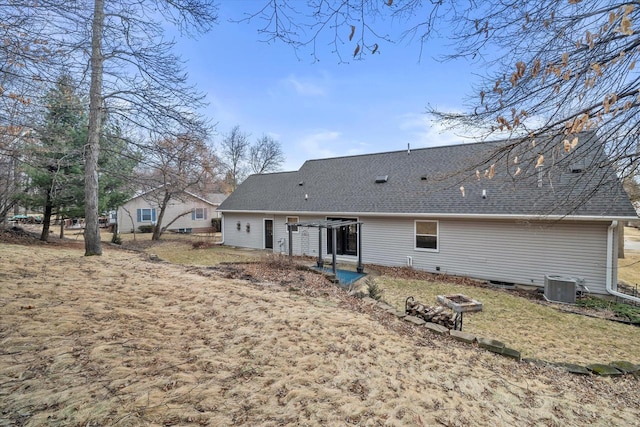 back of property featuring a shingled roof and central AC