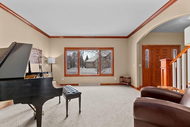 sitting room with carpet, crown molding, arched walkways, and baseboards