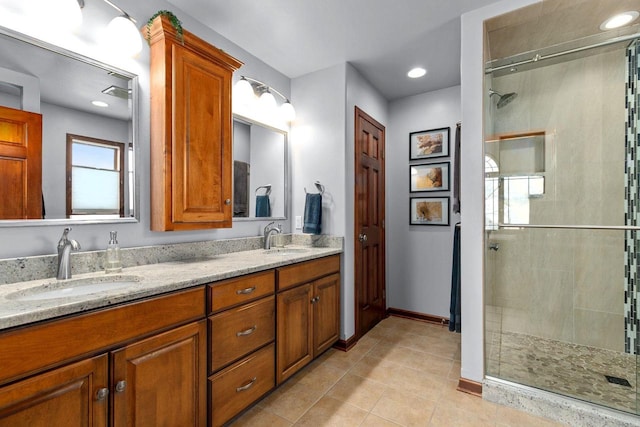 full bath with tile patterned flooring, a tile shower, and a sink