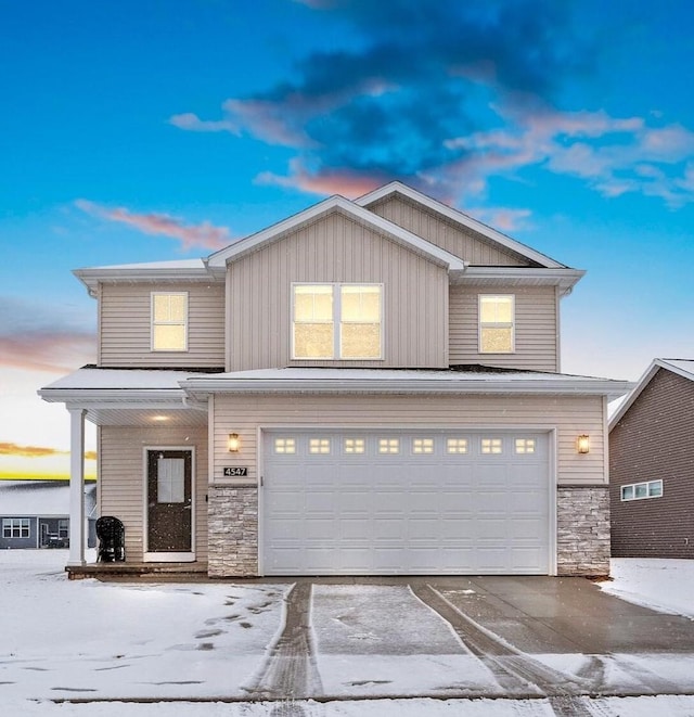 view of front of house featuring stone siding, concrete driveway, and an attached garage