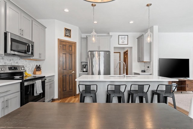 kitchen featuring appliances with stainless steel finishes and gray cabinets