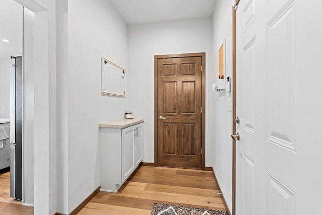 entryway featuring light wood finished floors and baseboards