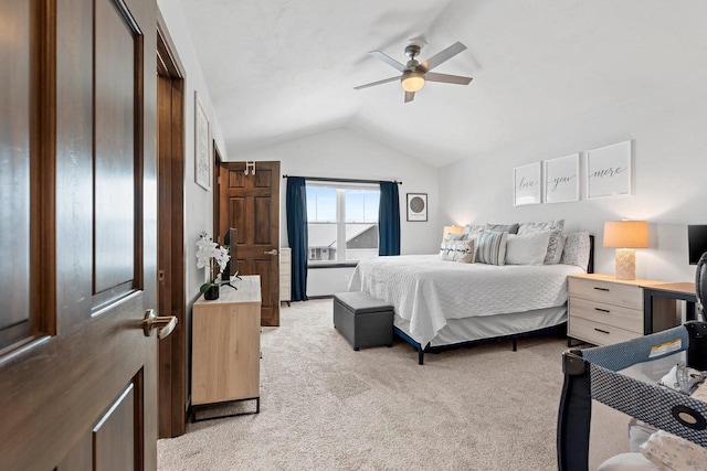 bedroom featuring a ceiling fan, light colored carpet, and vaulted ceiling