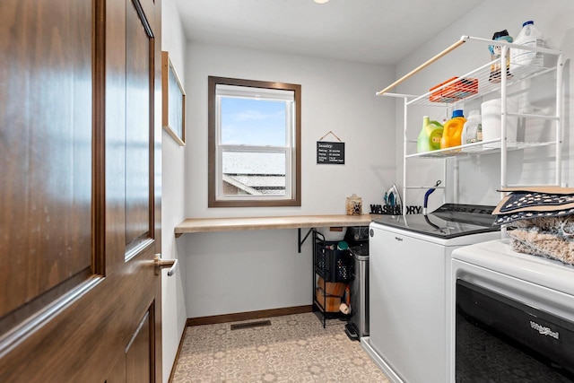 laundry room with laundry area, visible vents, baseboards, light floors, and washing machine and clothes dryer