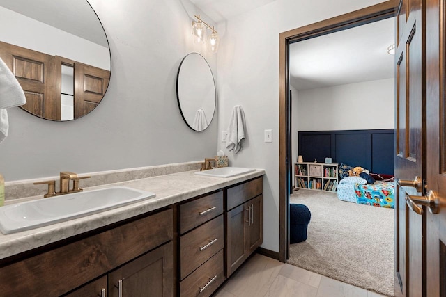 bathroom featuring a sink, ensuite bath, and double vanity