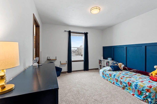 bedroom with light carpet and baseboards