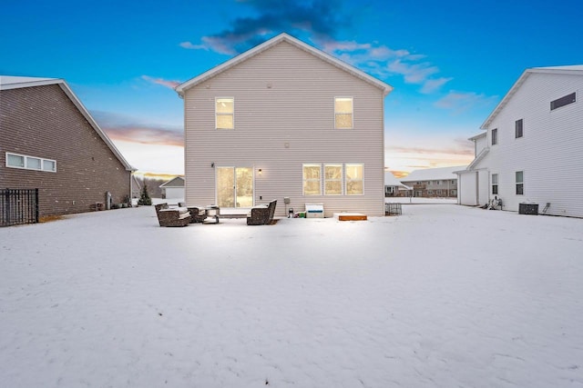 back of house at dusk with central AC unit